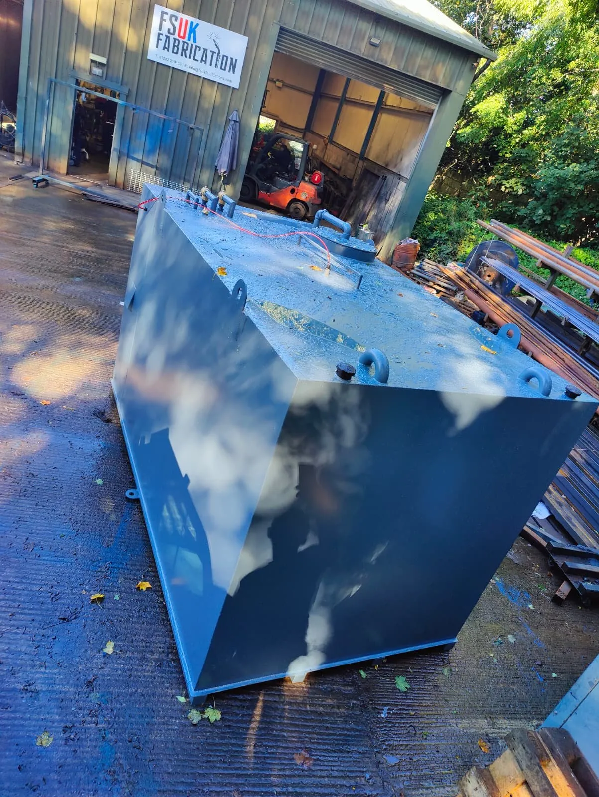 Top of a 10,000L generator feed tank showing the manway, vents and lifting eyes